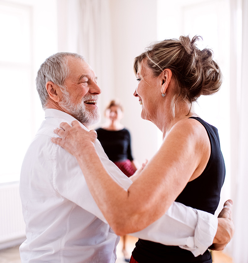 happy retired couple dancing