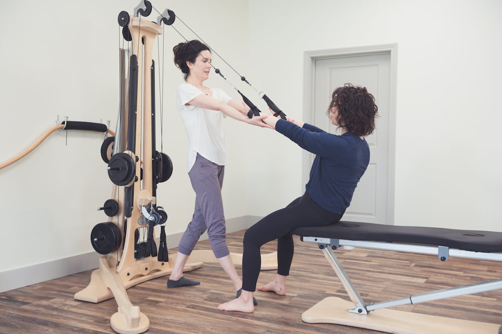 Leslie works with a student one on one in a private class