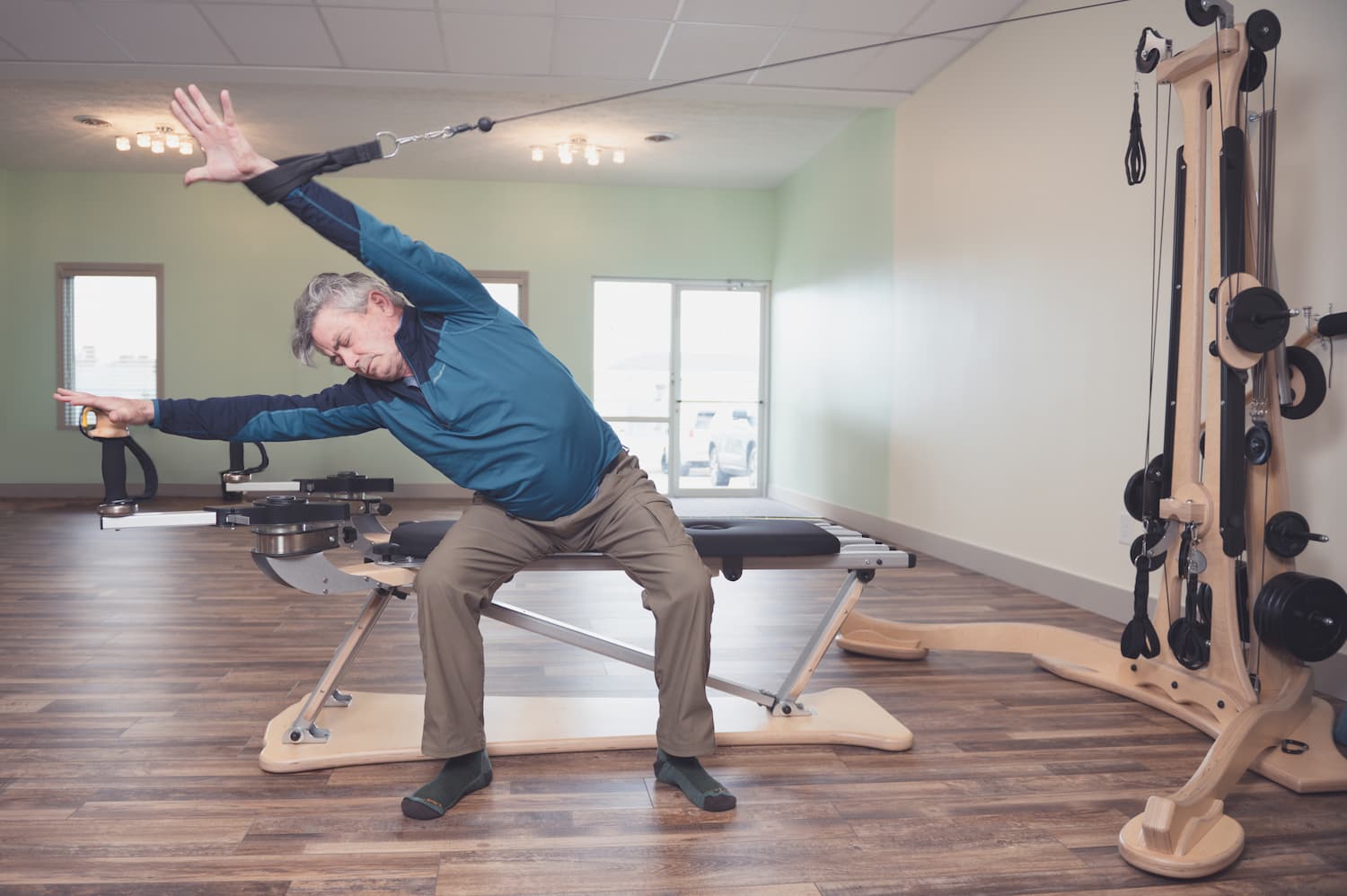 man stretching on a gyrotonic machine